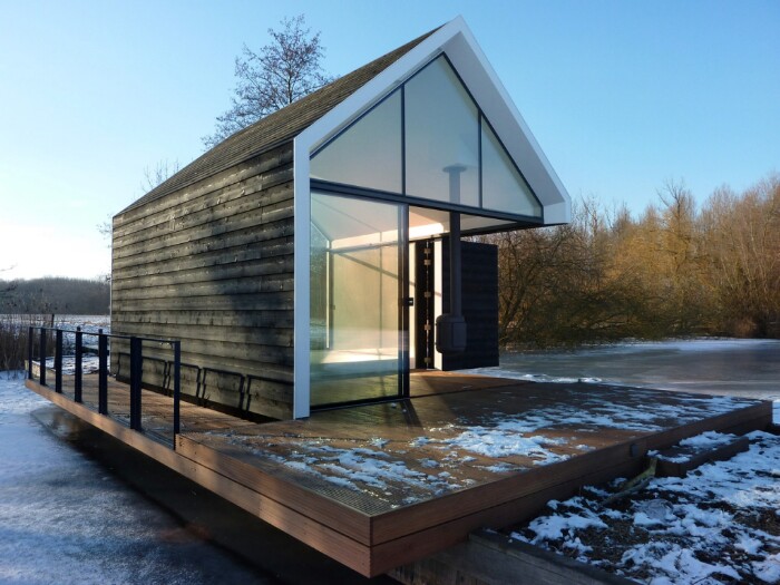 This Tiny Lake House Lets You Dive In For a Swim Right From the Living Room