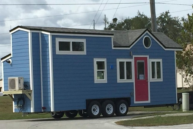 Tiny House on 26’ Trailer Charms with Porthole Windows and Bold Colors