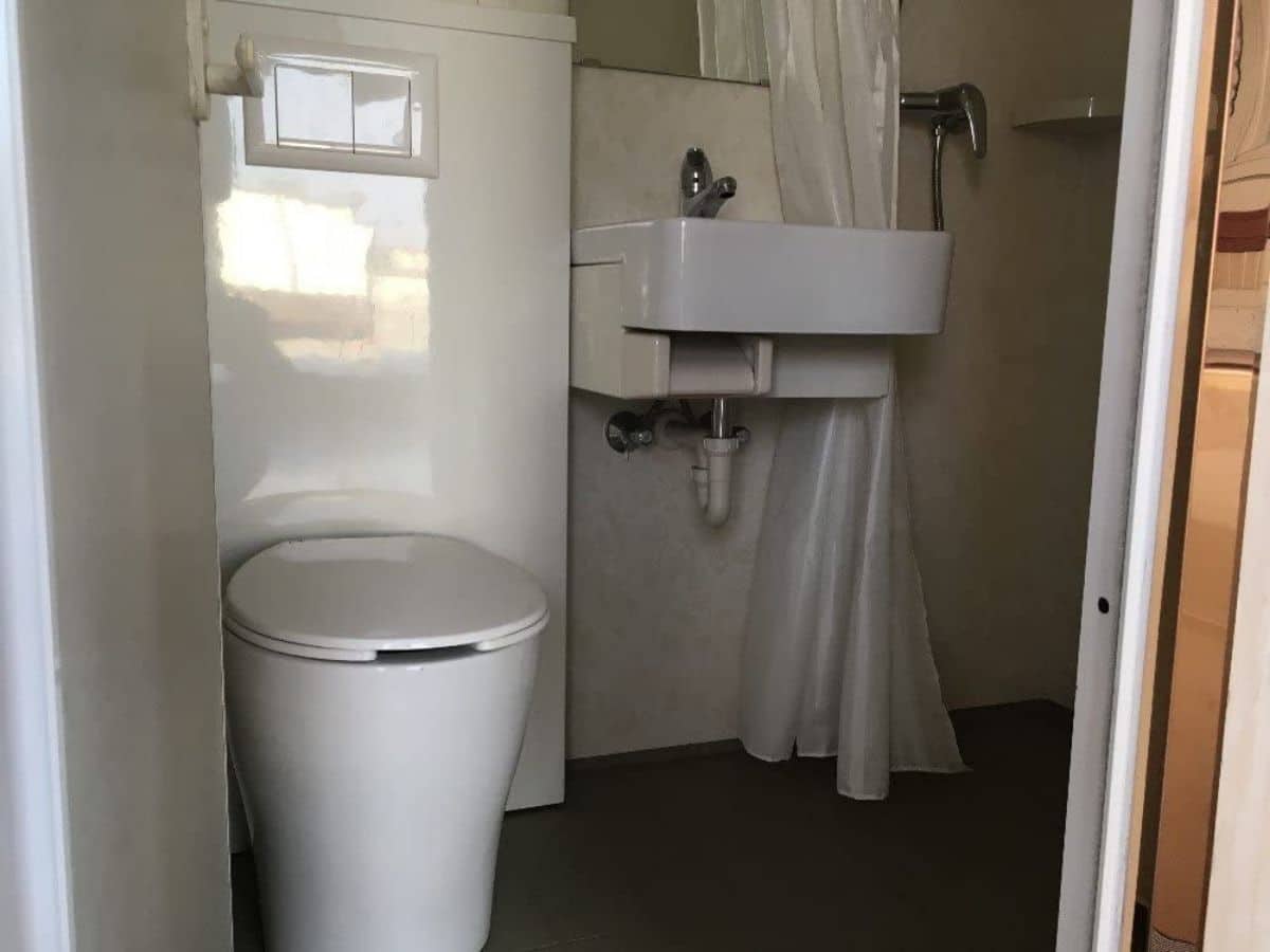 Tiny house bathroom with white sink and shower