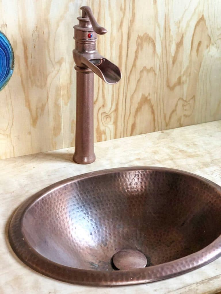 Copper sink in wood vanity