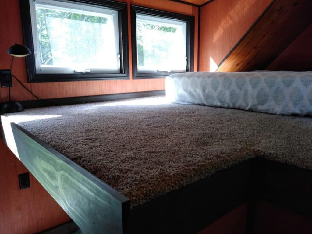 Bed in loft of cabin