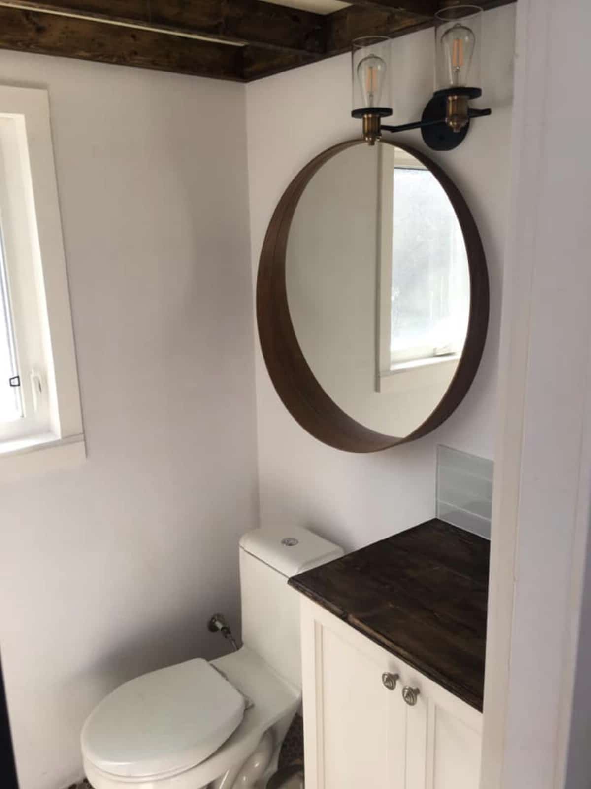 Bathroom with large round mirror