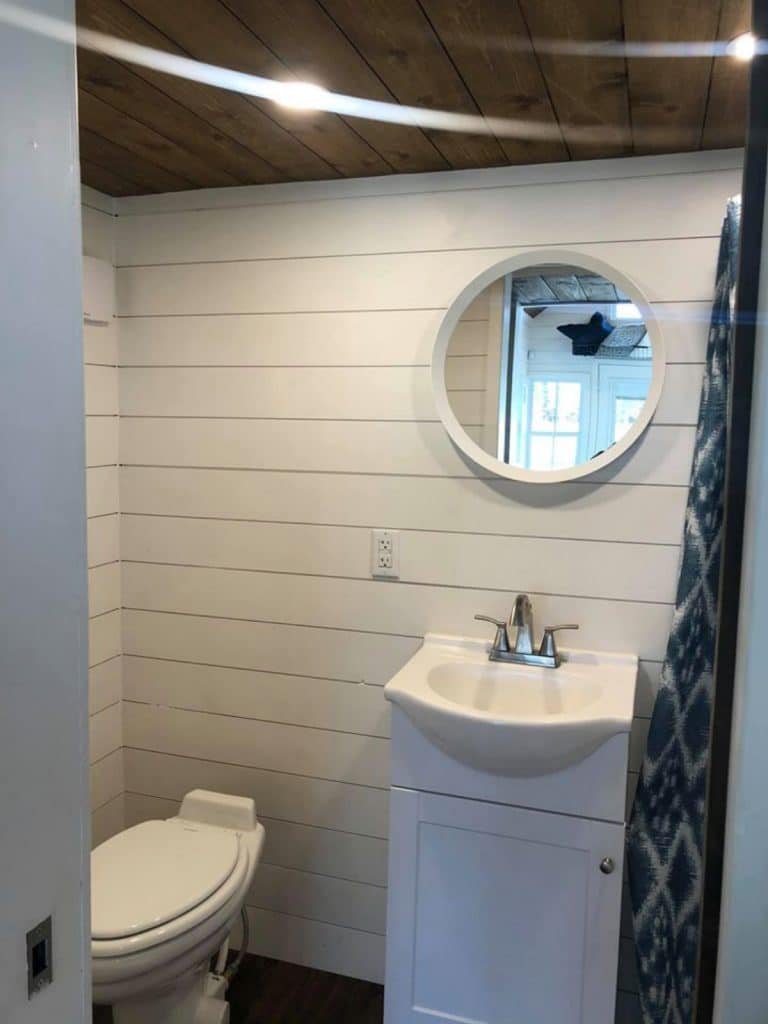 White shiplap bathroom wall with vanity