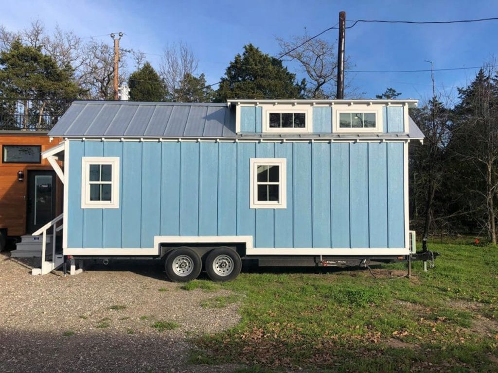 Side of blue cottage with loft