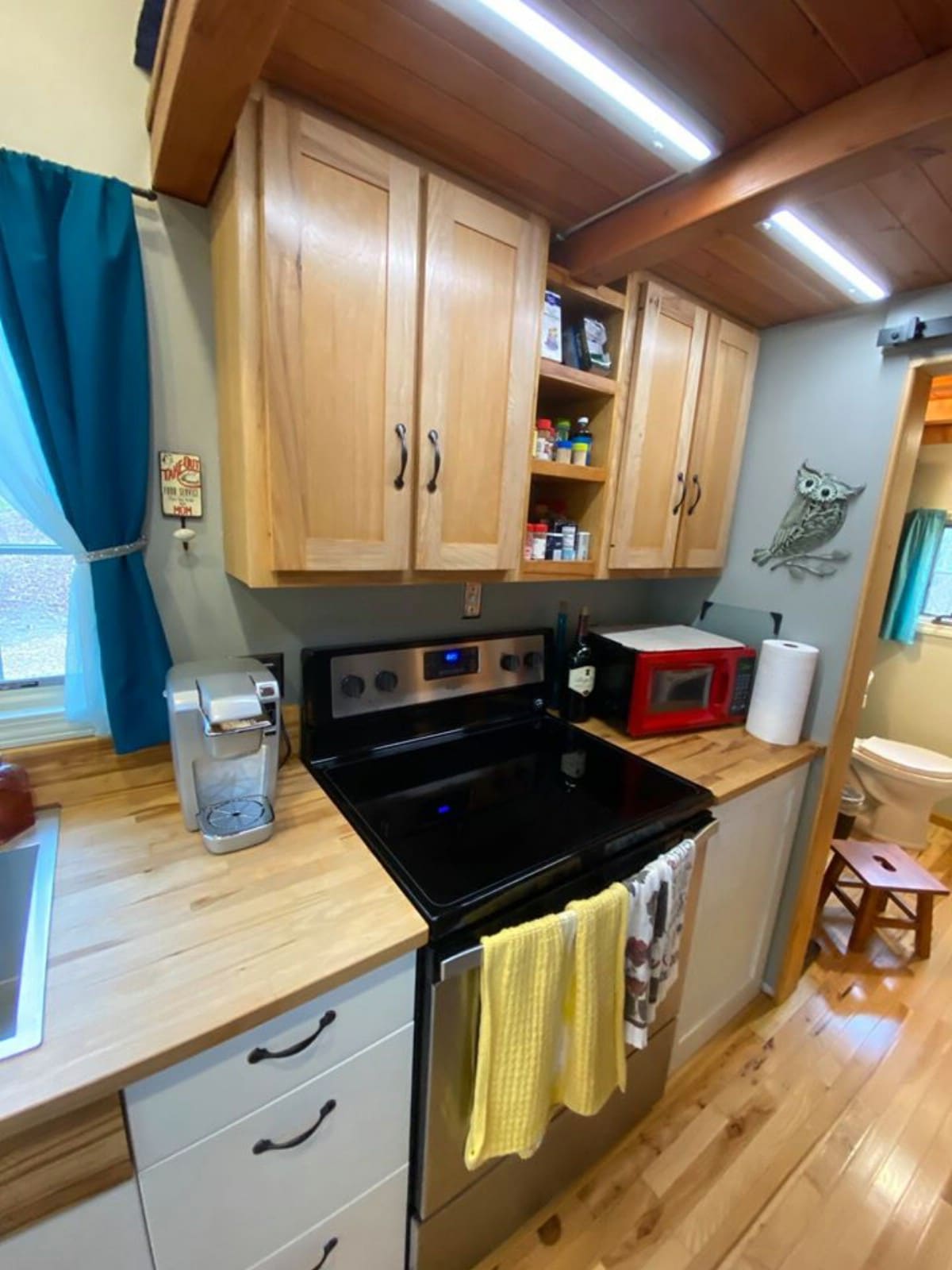Range in tiny home kitchen with blonde cabinet