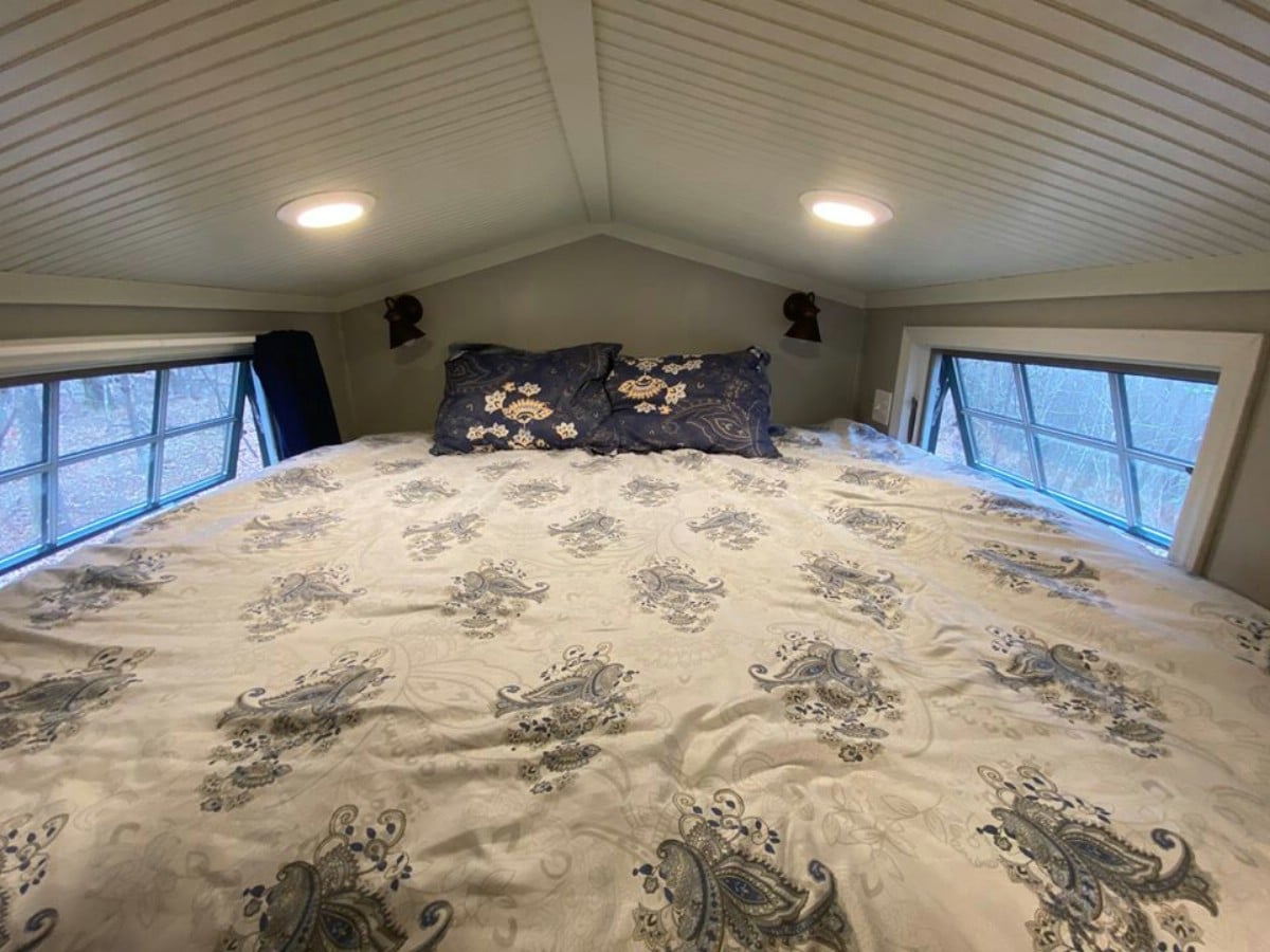 White and grey bedding in loft cabin