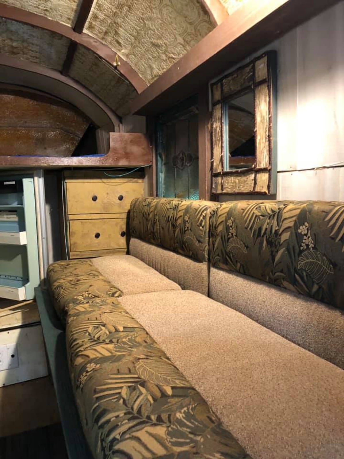 Couch in camper with mirror