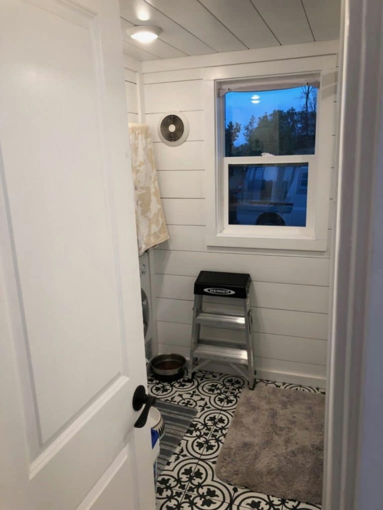 Toilet in tiny house with shiplap walls