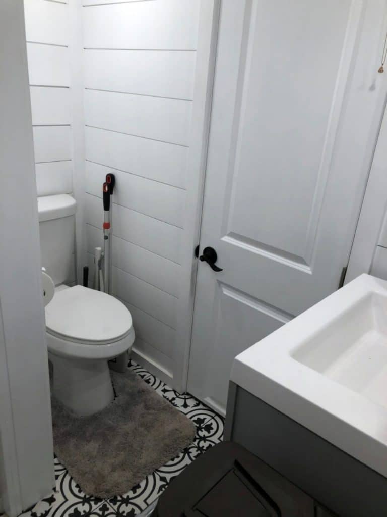 Toilet in tiny house with shiplap walls