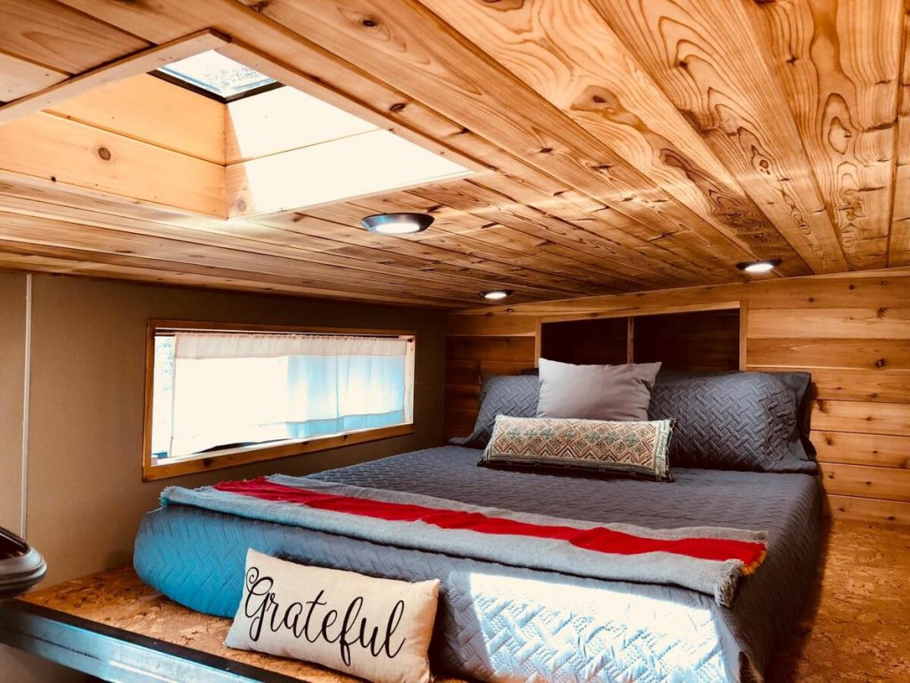 Loft bedroom with rustic ceiling