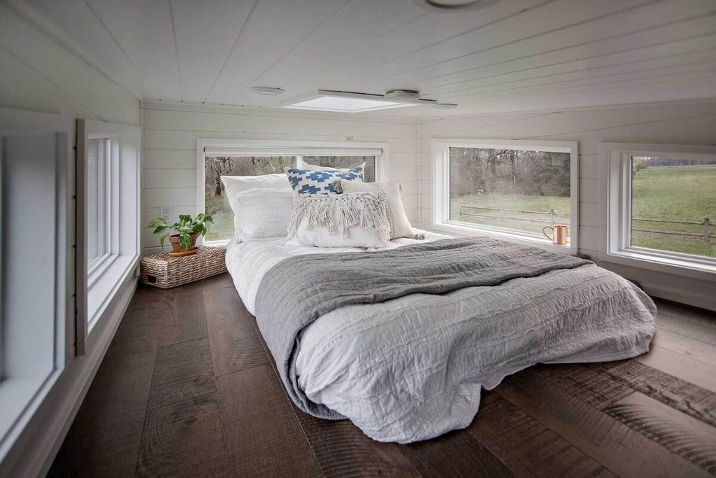Bed in breezeway tiny house