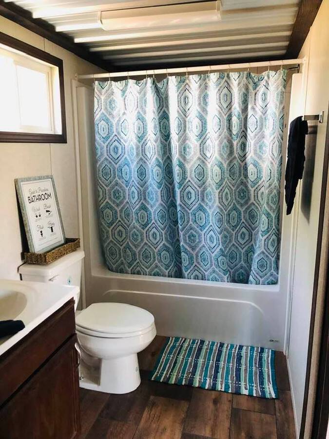 Bathroom with blue shower curtain