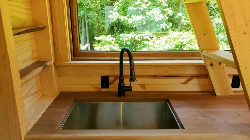 Sink in stained wood kitchen