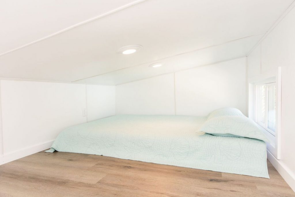Loft bedroom with aqua bedding