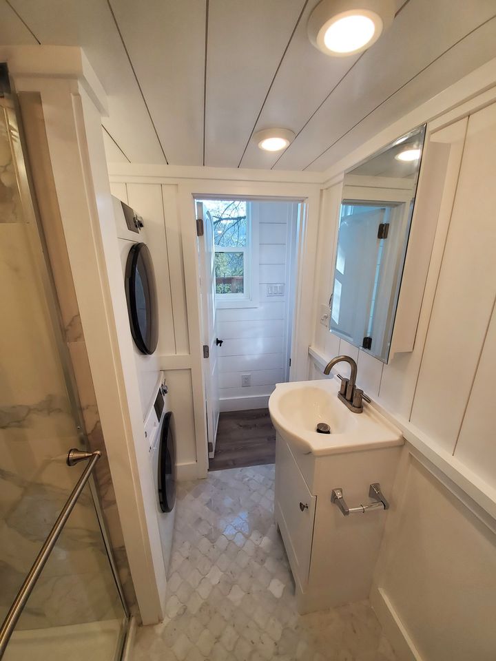 Tiny house white bathroom with laundry