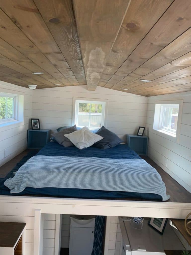 Loft bedroom with blue bedding