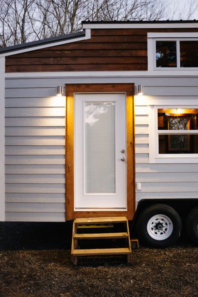 Grey tiny house with side door