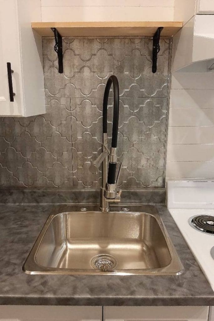 Kitchen sink with chrome backdrop