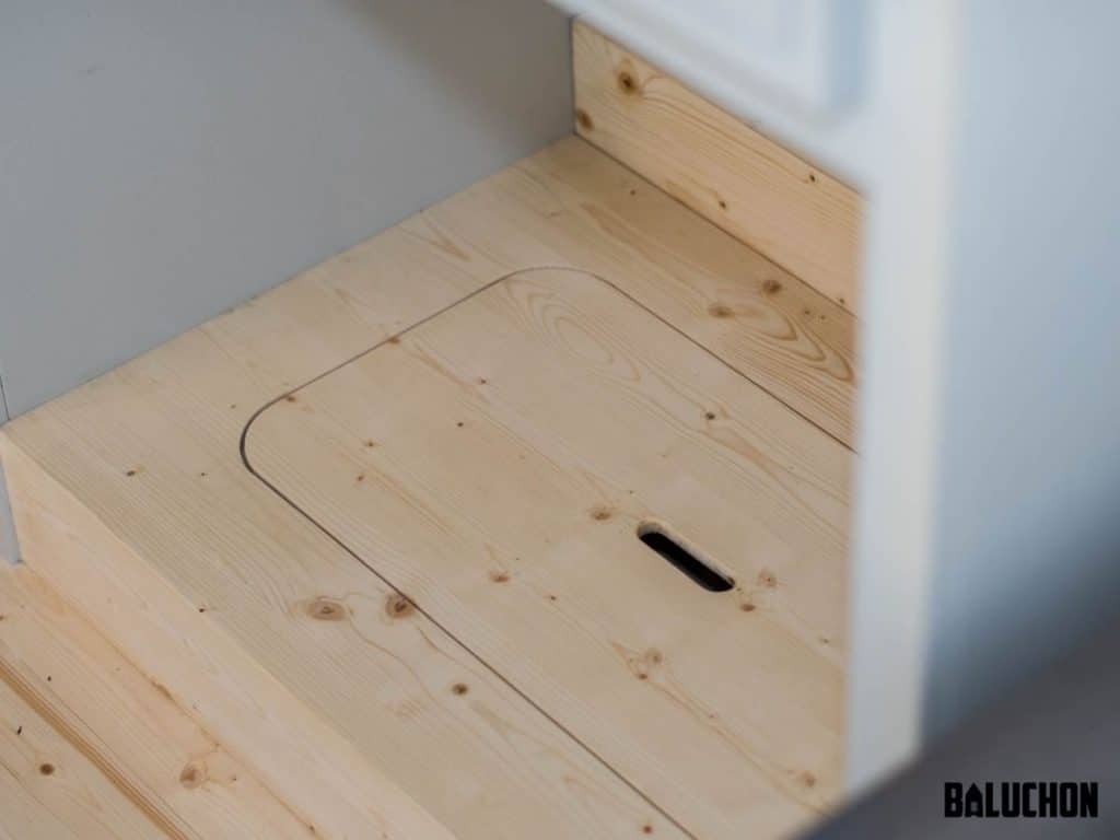 Hidden pocket in tiny house stairs