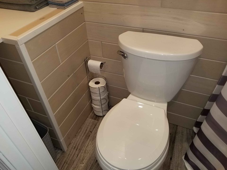White toilet against tan bathroom walls