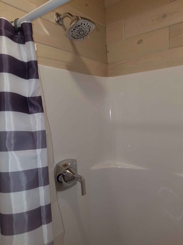 Shower stall with striped shower curtain