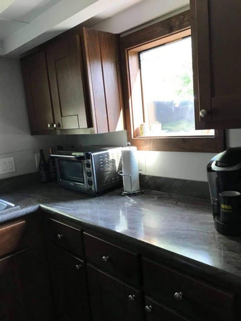 Kitchen counter with window between cabinets