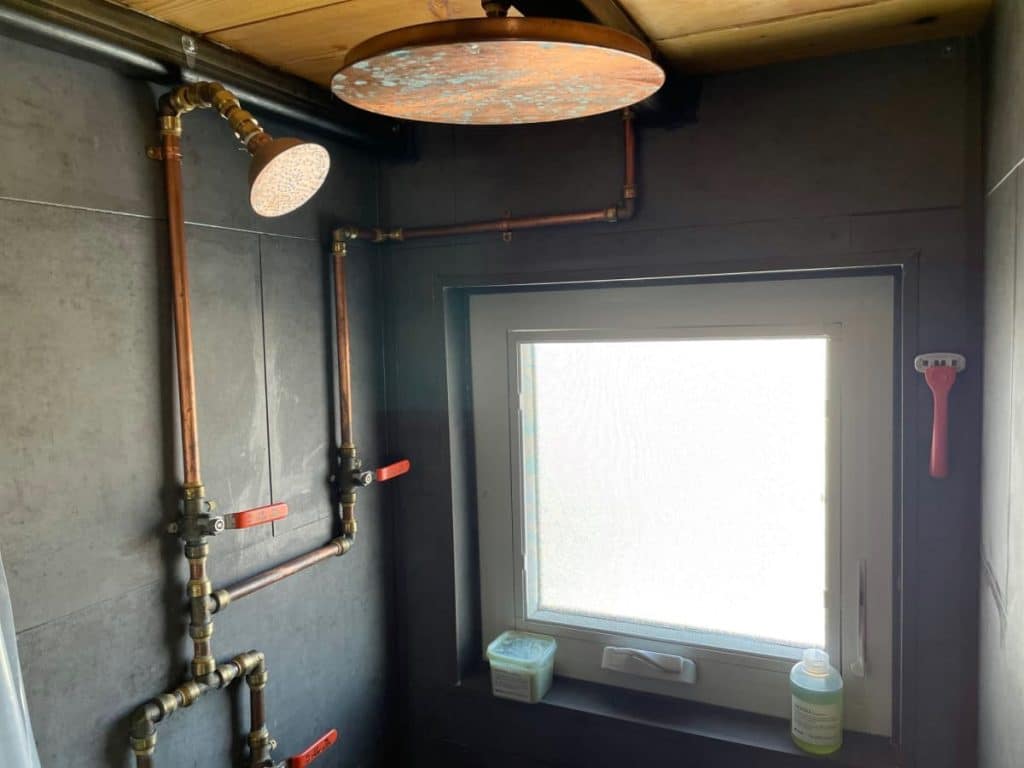 Bathroom shower with visible pipes