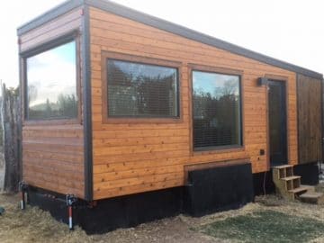Brown tiny house with black trim