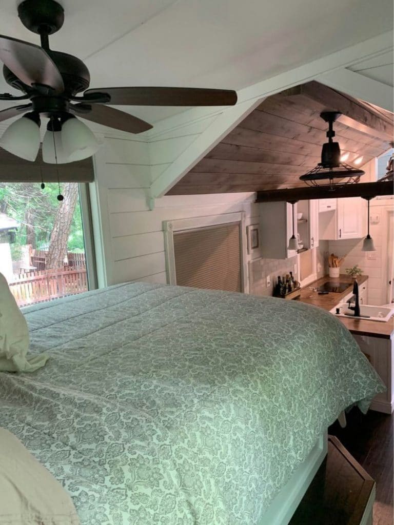 Bed on pedastal with ceiling fan above