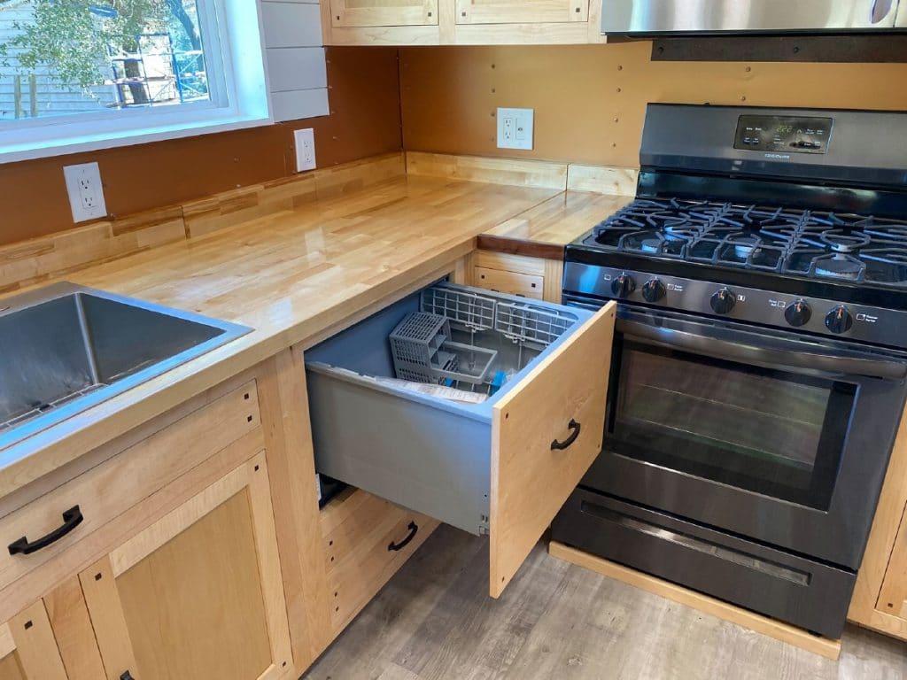 Drawer with dishwasher inside beside stove