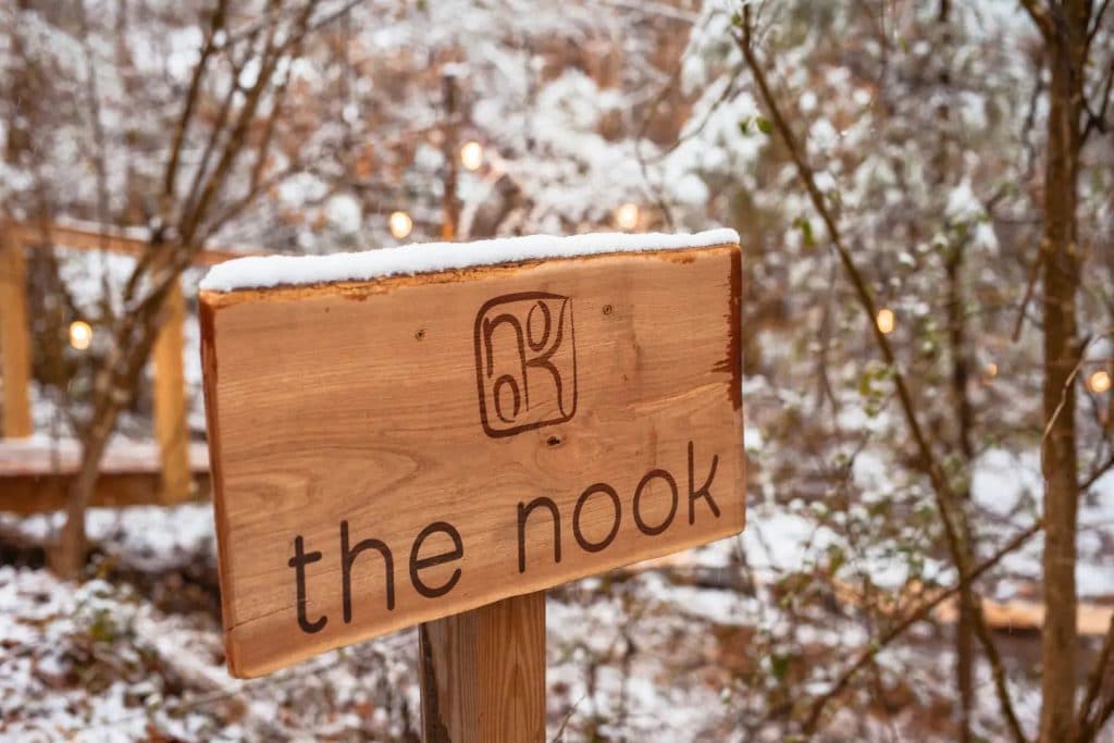 Wooden sign on steak that says the nook