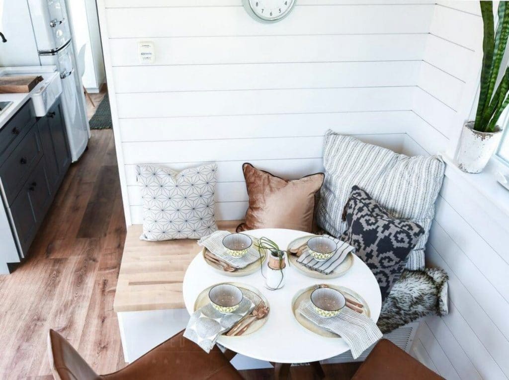 White shiplap walls in corner with table
