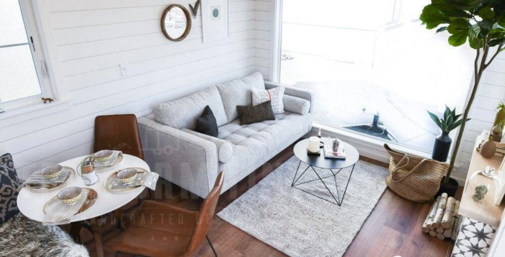 Grey sofa in living space with wood floor