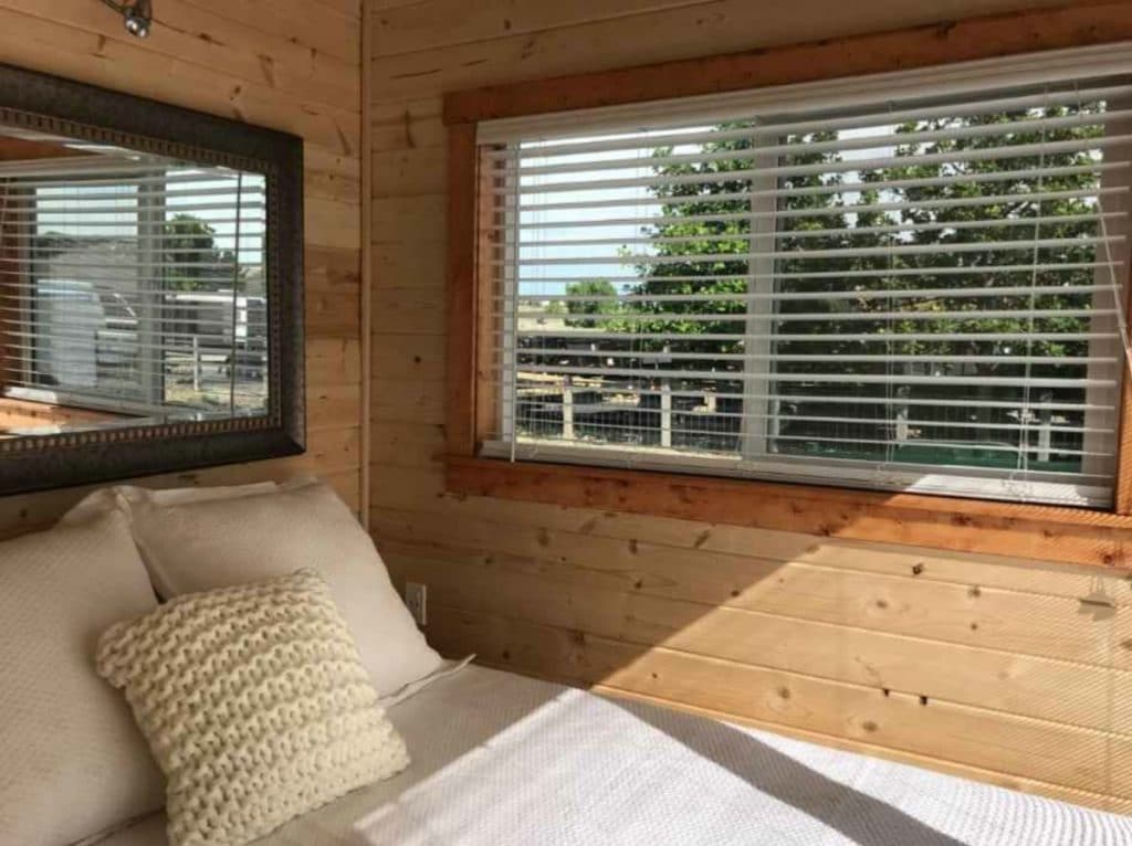 Windows by bed in corner of loft