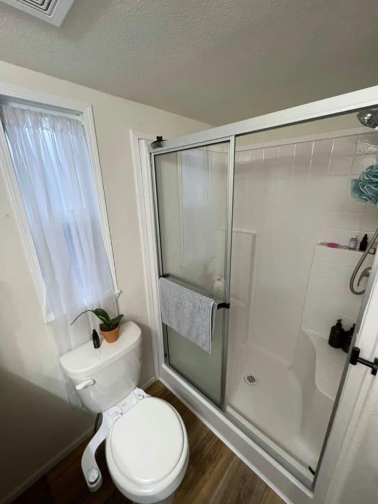 Tiny bathroom shower with sliding glass door