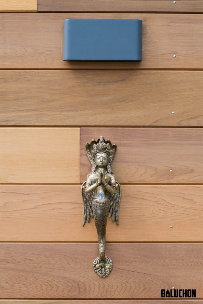 Mermaid sconce on exterior of tiny house