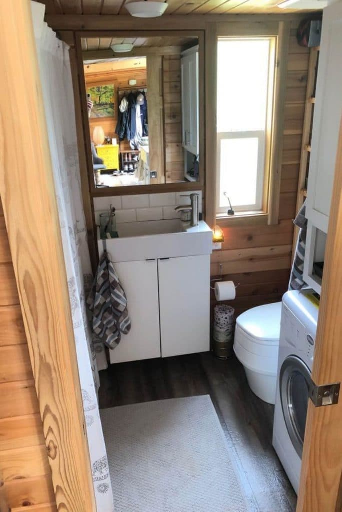 View into bathroom from door showing white vanity and compost toilet