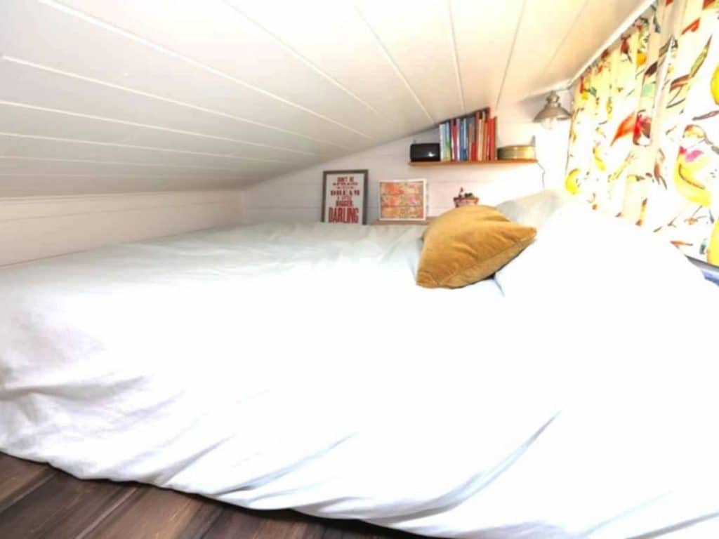 Loft bedroom with large white bed