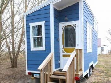 Front of blue tiny house with white trim