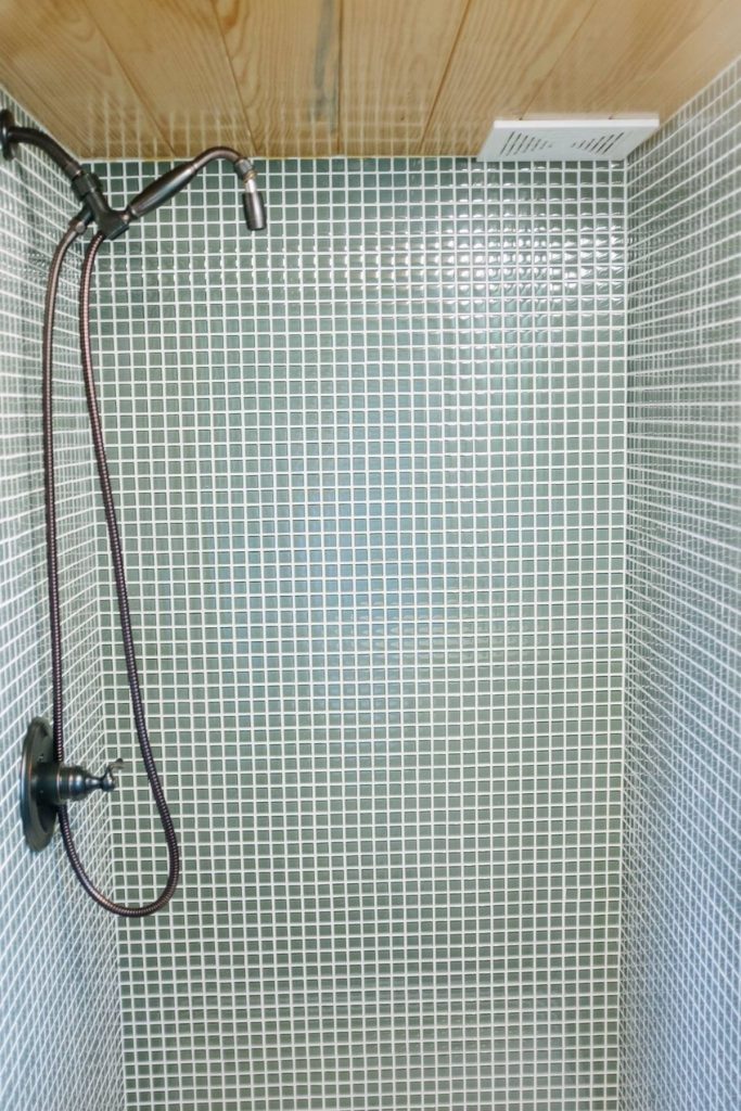 Tiled shower with light blue and white tiles