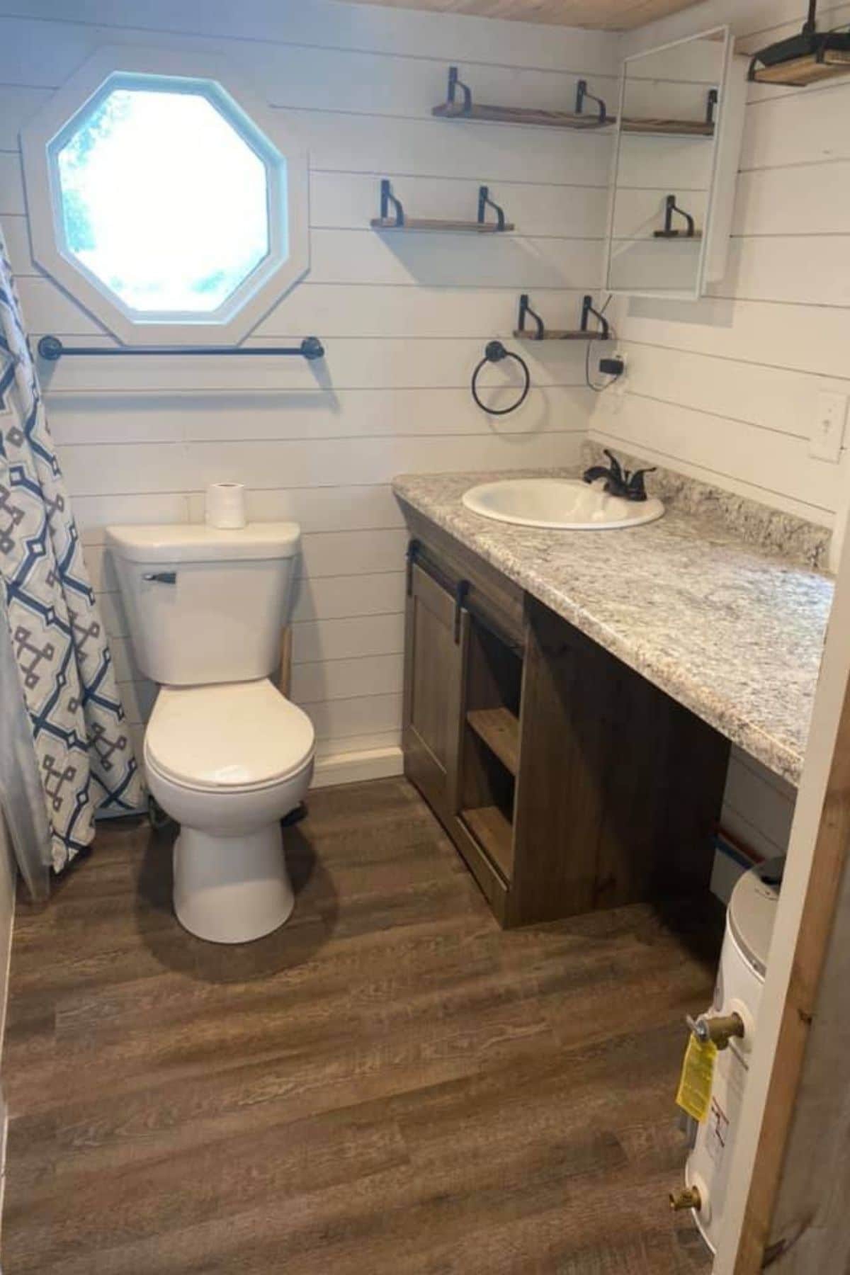 Bathroom with wood floor toilet and vanity with single sink
