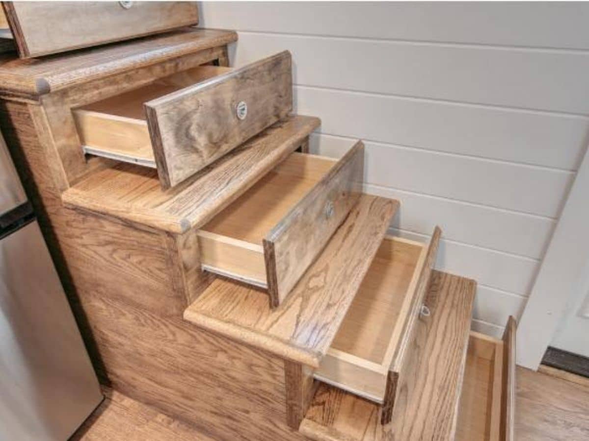 Stairs drawers opened against white wall