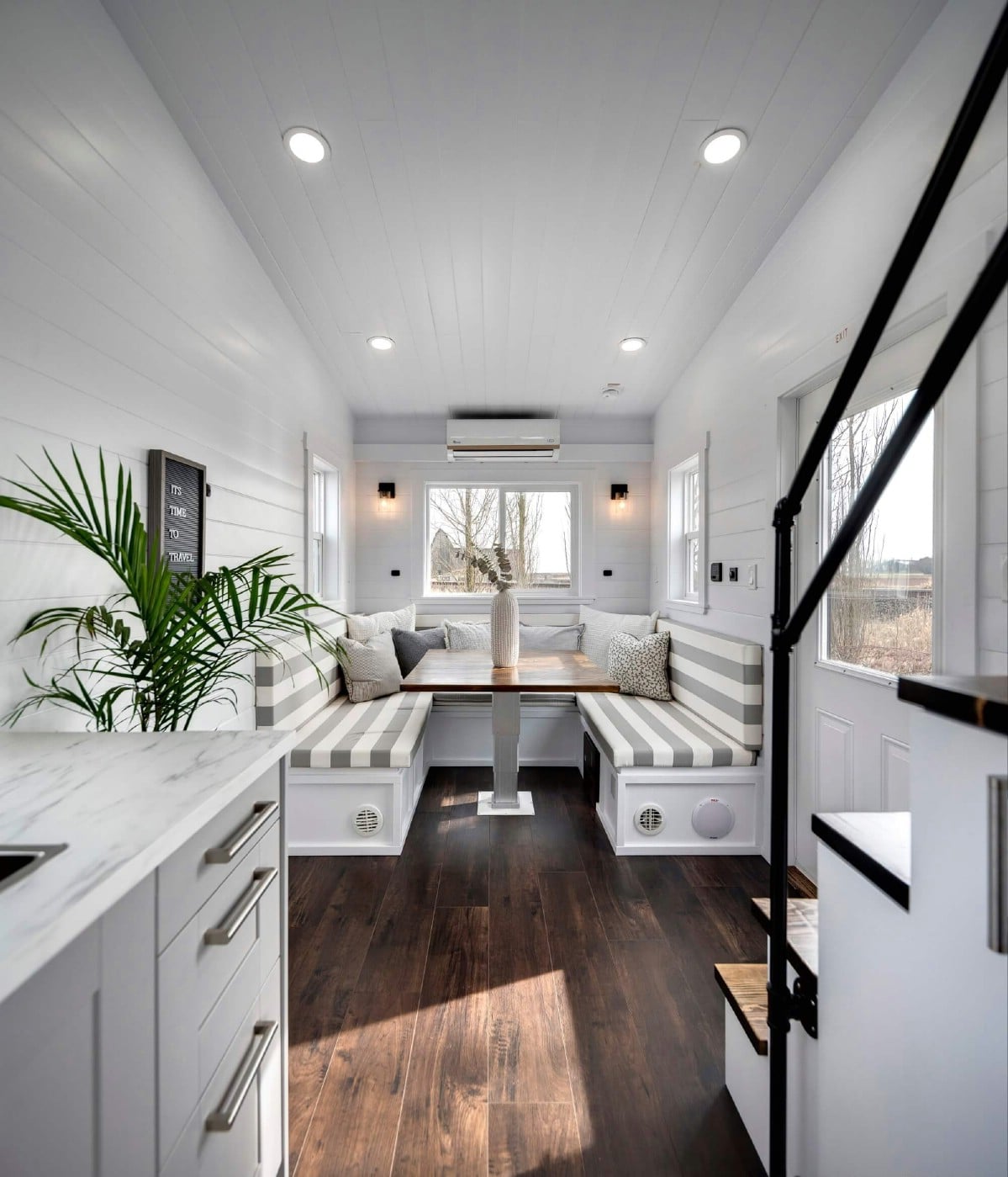 View into living area of tiny home from behind stairs