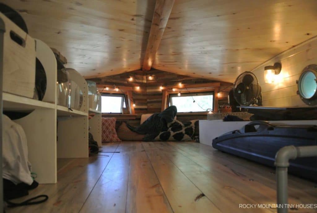 View into tiny home loft with two windows at end