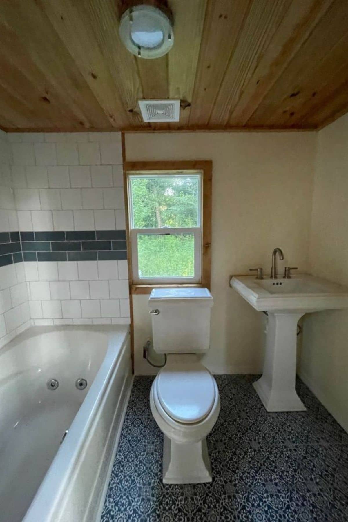 View into white bathroom with bathtub on left