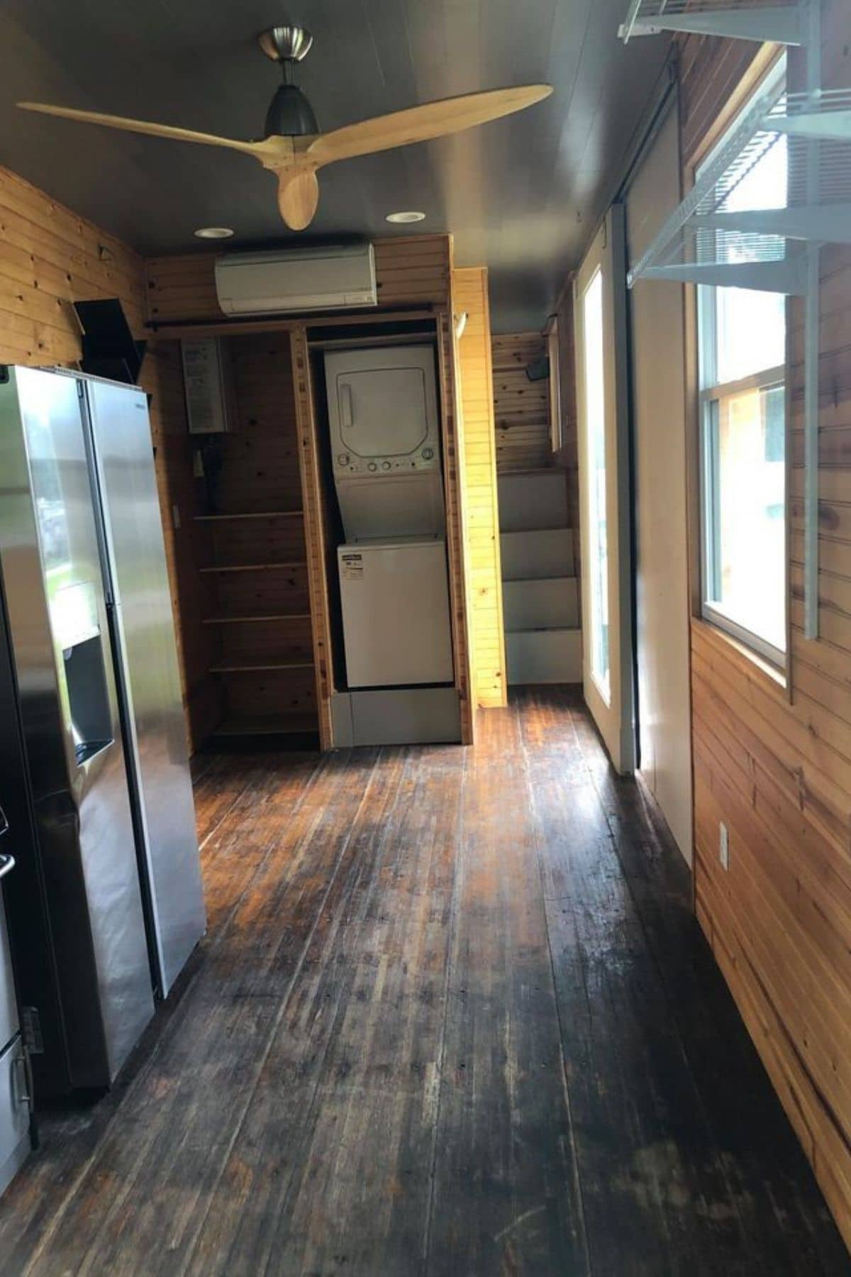 View looking into tiny home showing laundry stack at back of room
