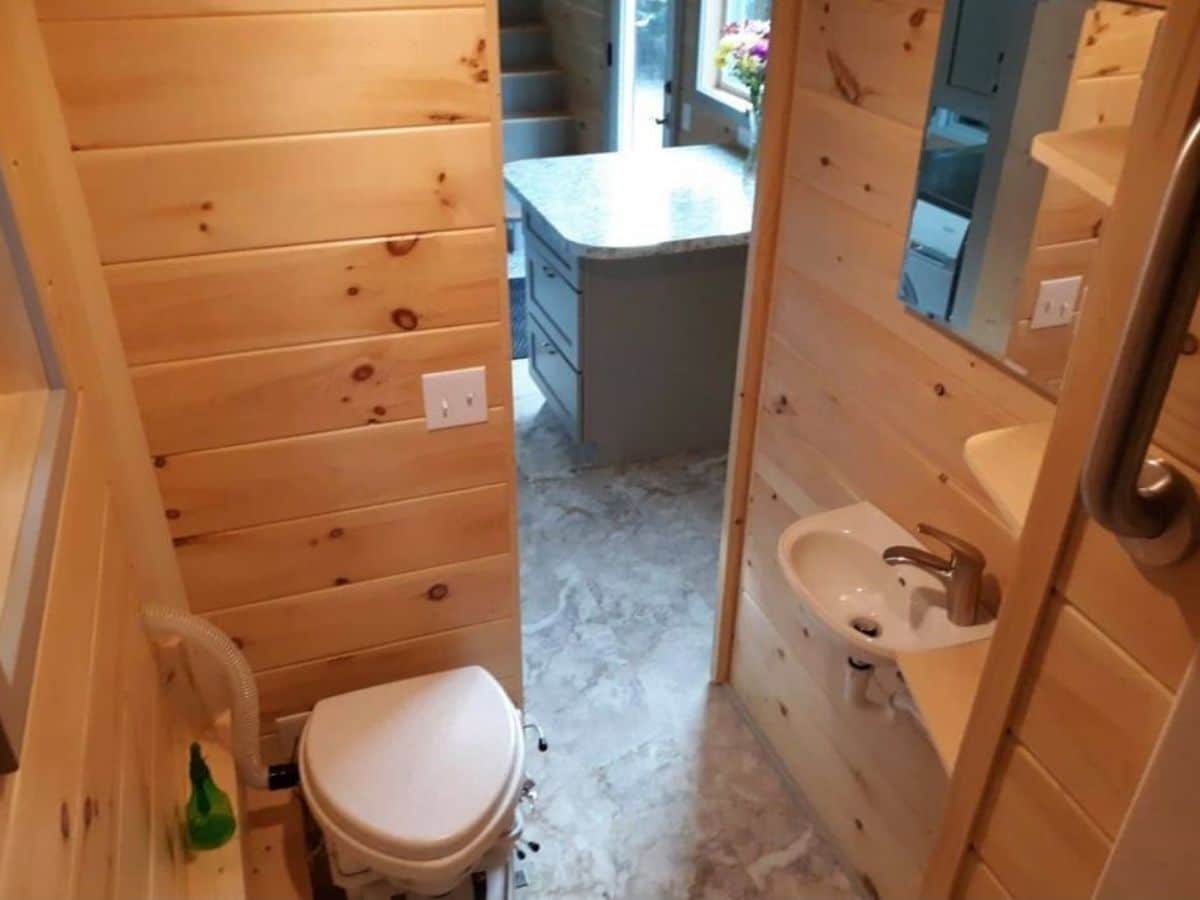Composting toilet in tiny home with wood walls