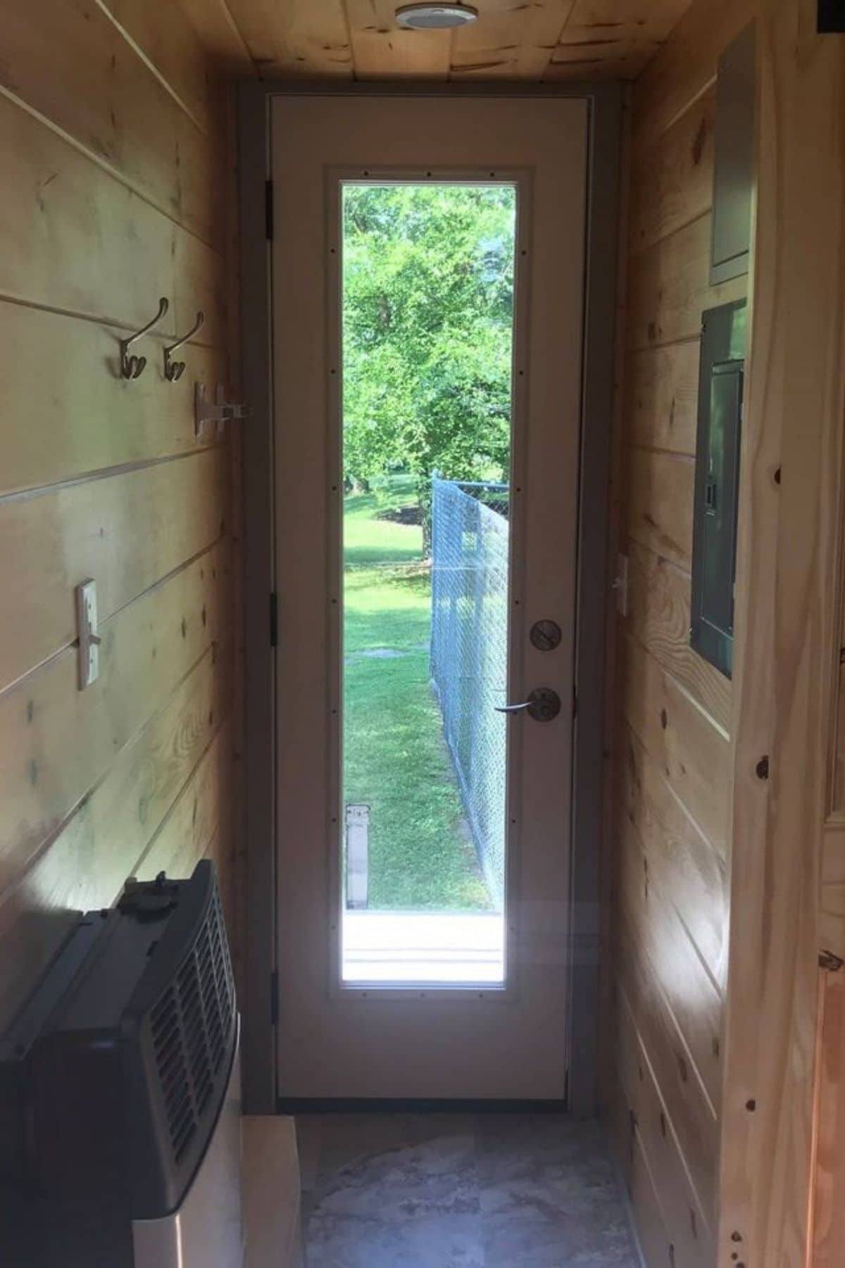 Door with glass panel in entry to tiny home