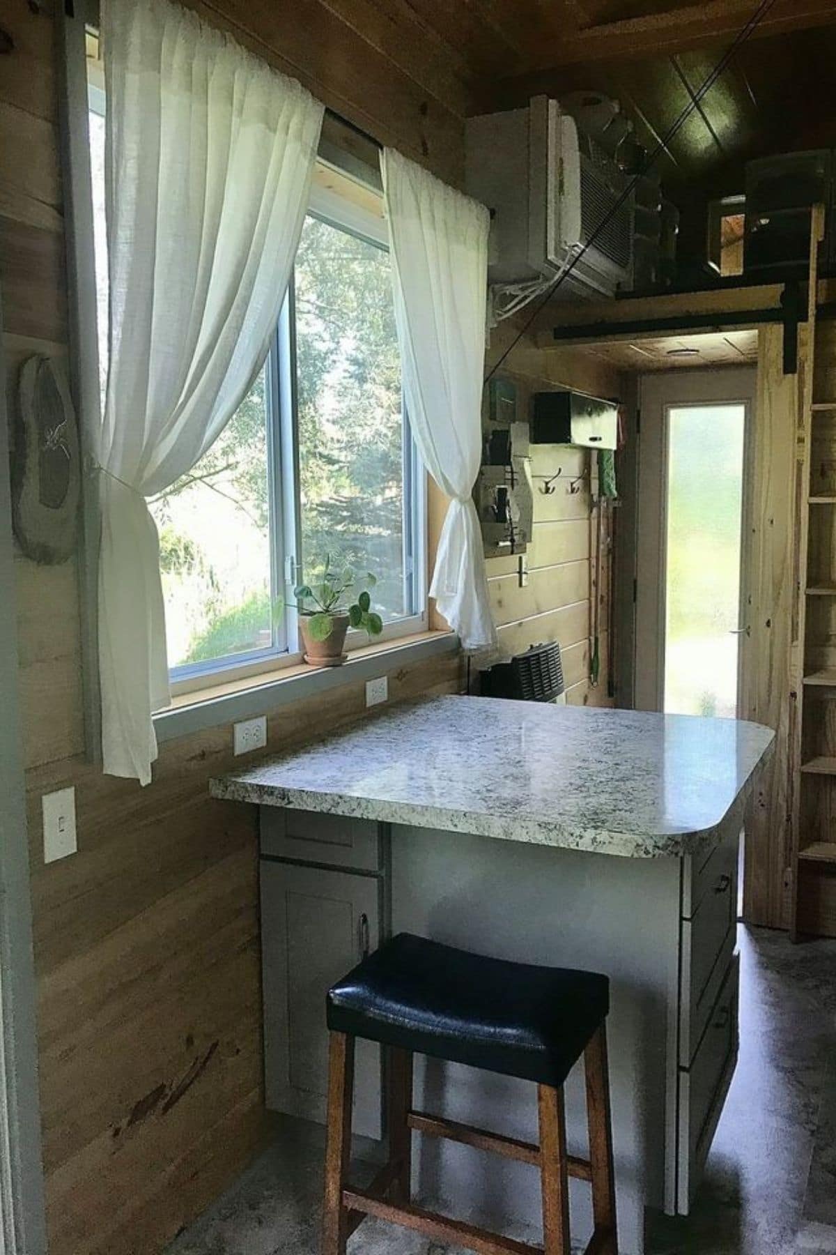 Table under window with bar stool