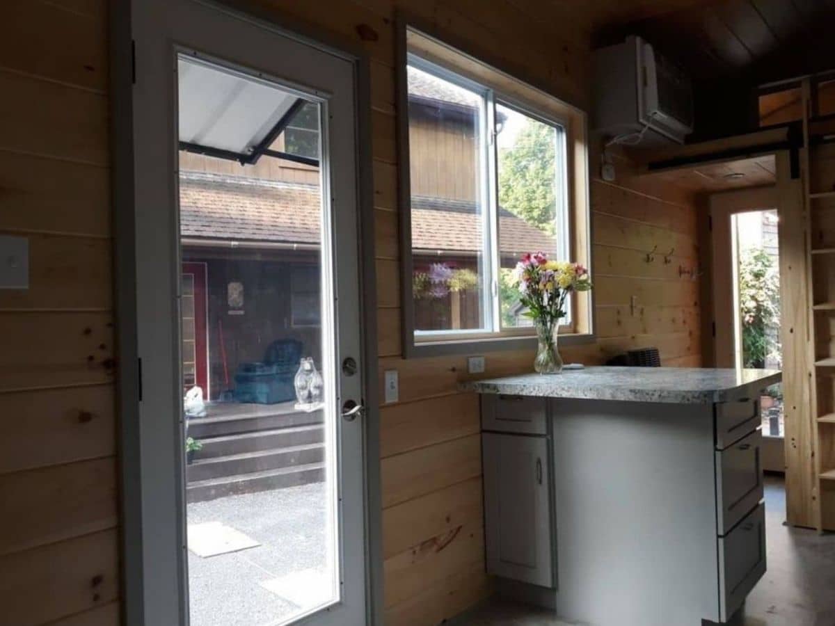 Door of tiny home next to table